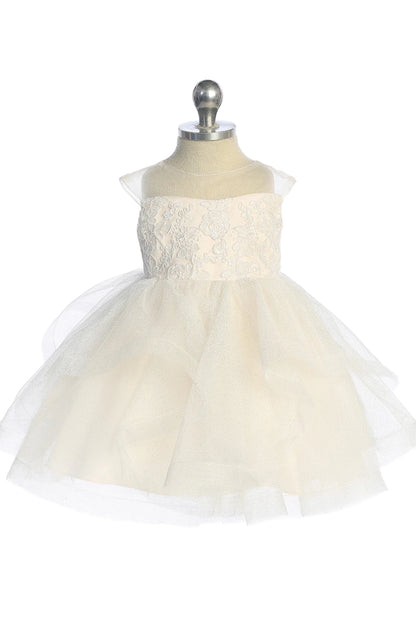 Folded tulle creates soft skirt swags on this champagne flower girl dress.