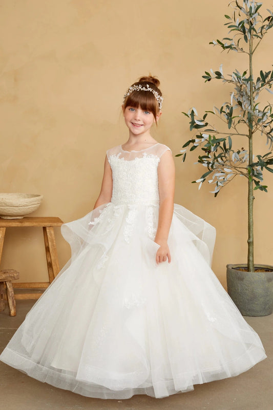 Angular tulle swags fan from the off-white flower girl dress's waist.