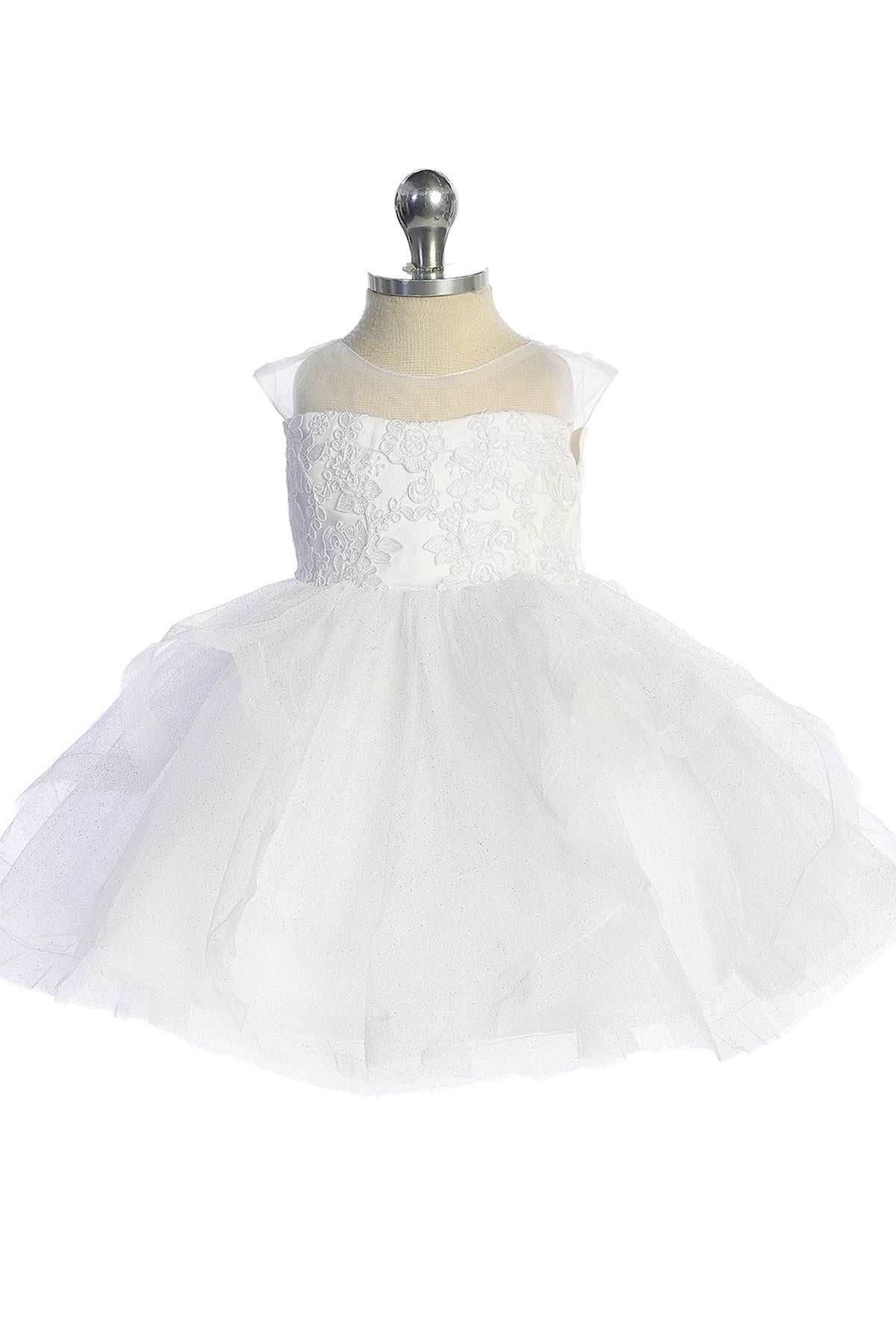 A view of a gathered tulle skirt on the white flower girl dress.