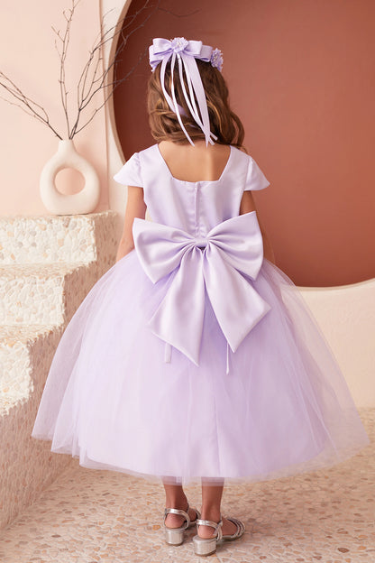 The Lilac kids pageant dress has a large satin bow and square back neckline.