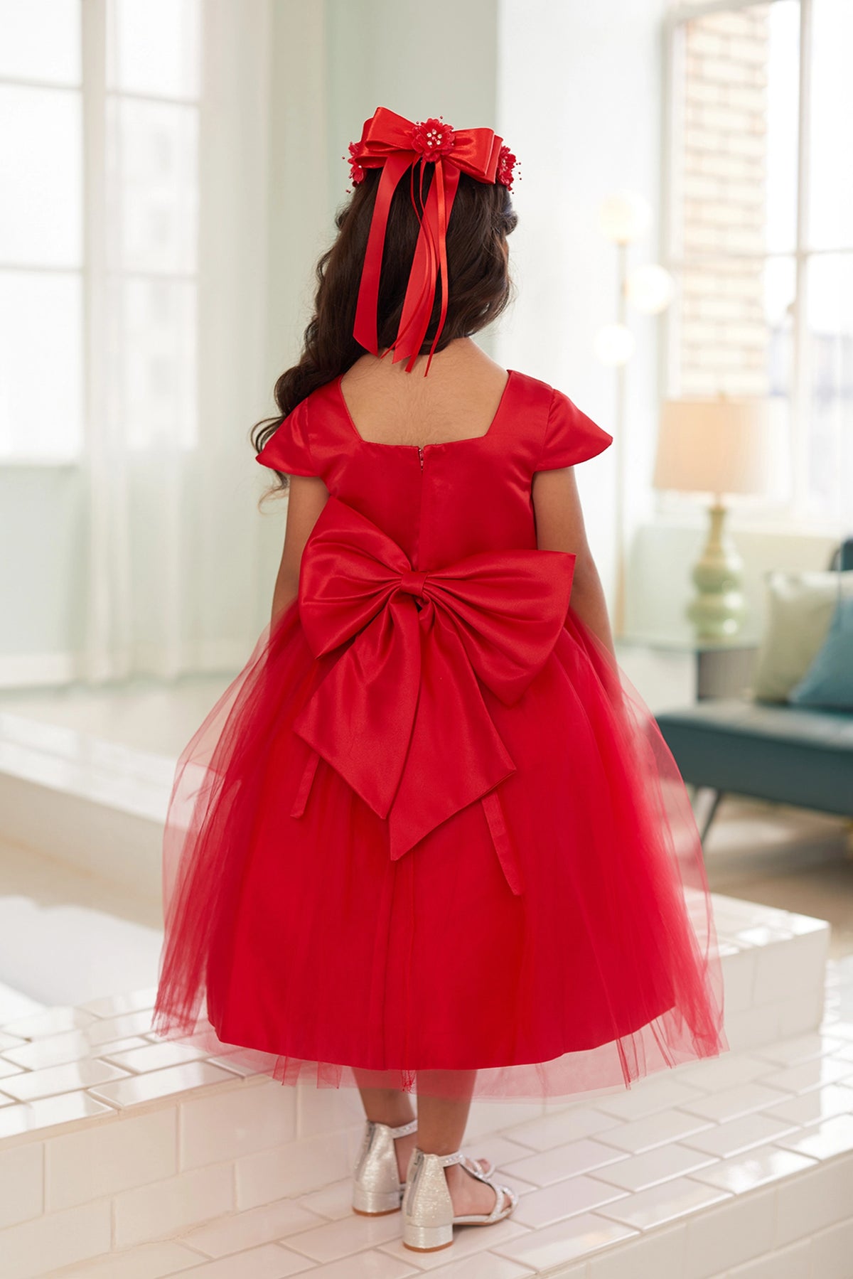 The Red kids pageant dress has a large satin bow and square back neckline.