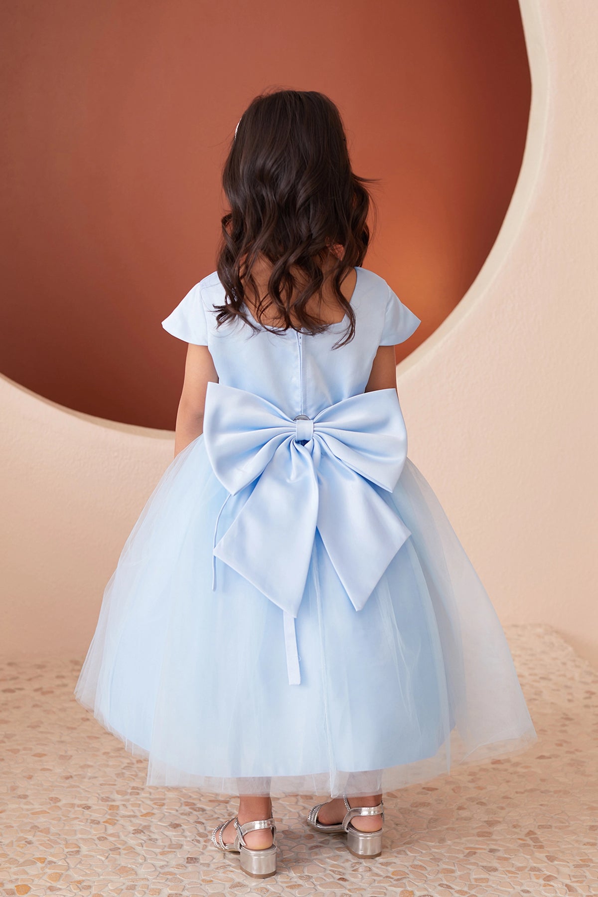 Sky Blue kids pageant dress featuring a large satin bow and square back neckline.