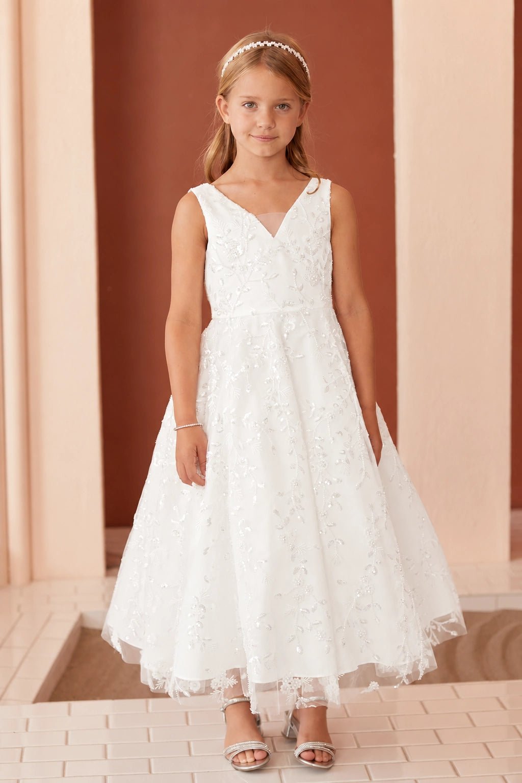 Visible on the off-white flower girl dress: a floral V-neck bodice.