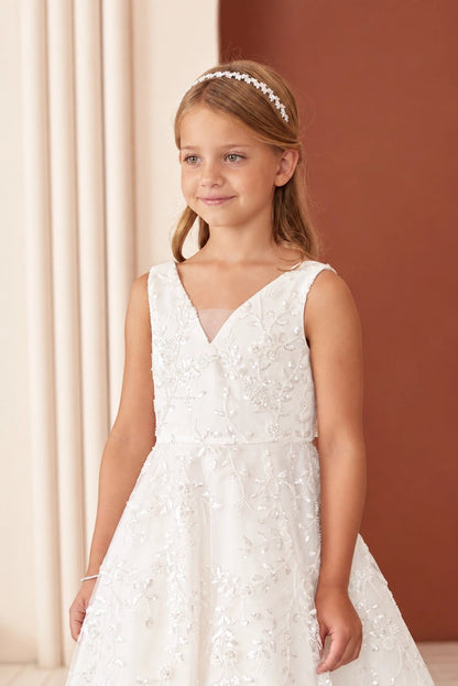 A view of an embroidered V neckline on the off-white flower girl dress.
