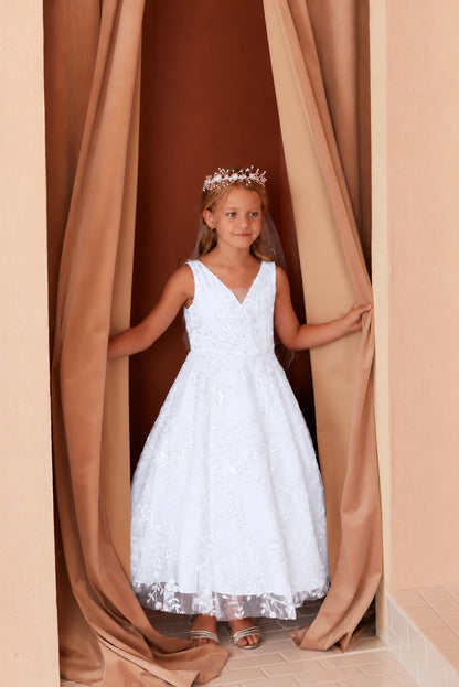 Embroidered stems extend beyond the white flower girl dress's hem.