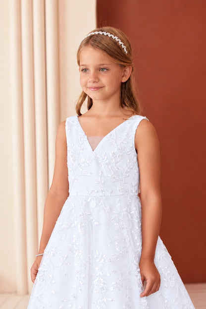 Inside the V neckline, the white flower girl dress has a sheer mesh inset.