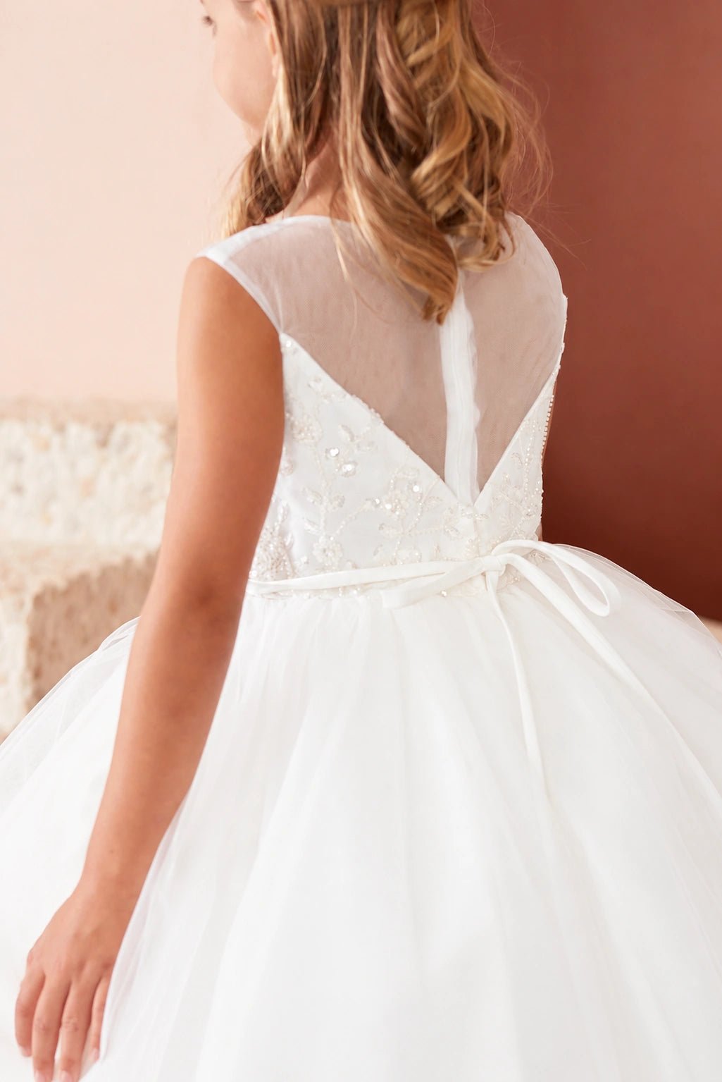 Rear detail of the ivory beaded floral lace with a mesh skirt flower girl dress.