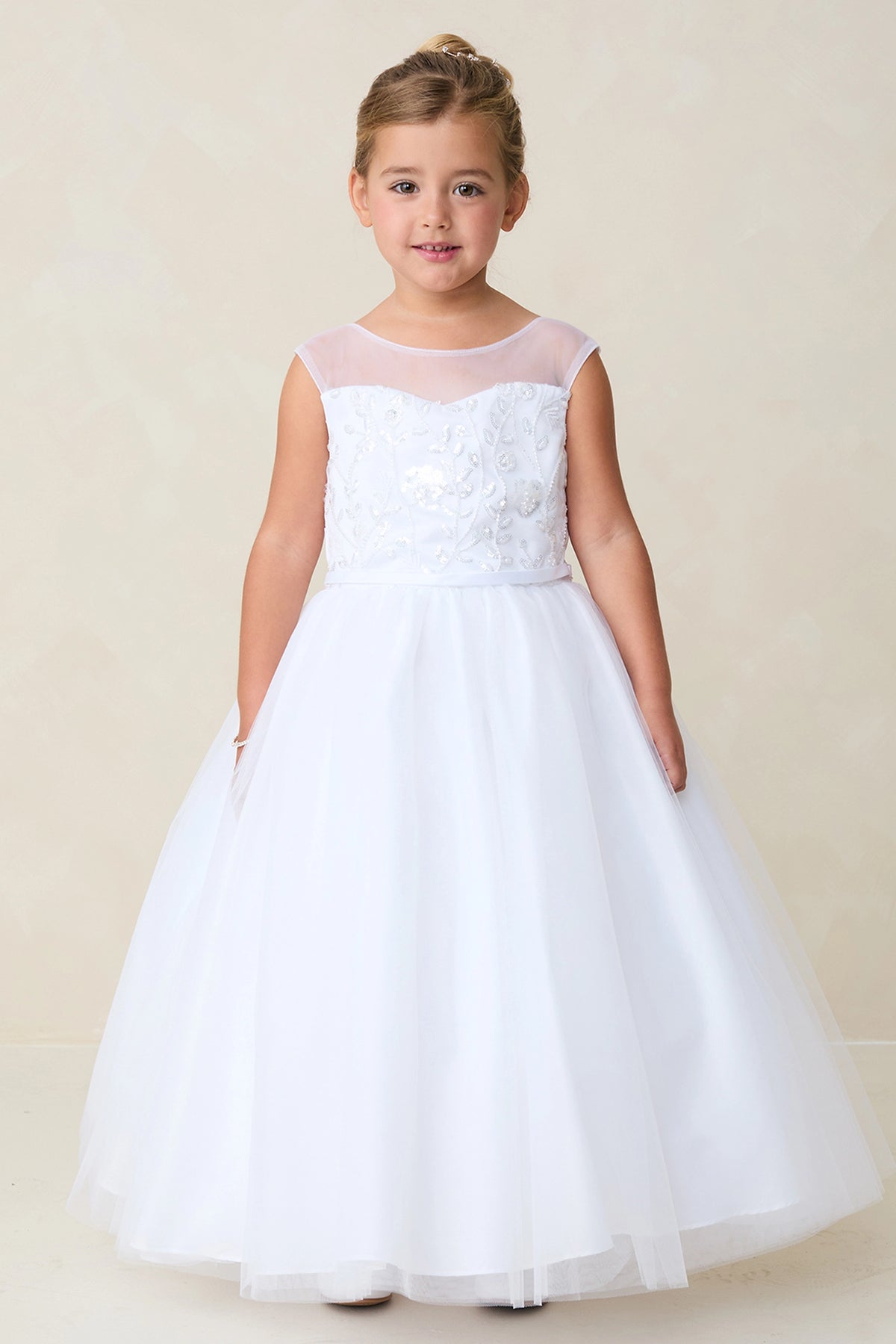 Highlighting a floral lace bodice on a white flower girl dress.