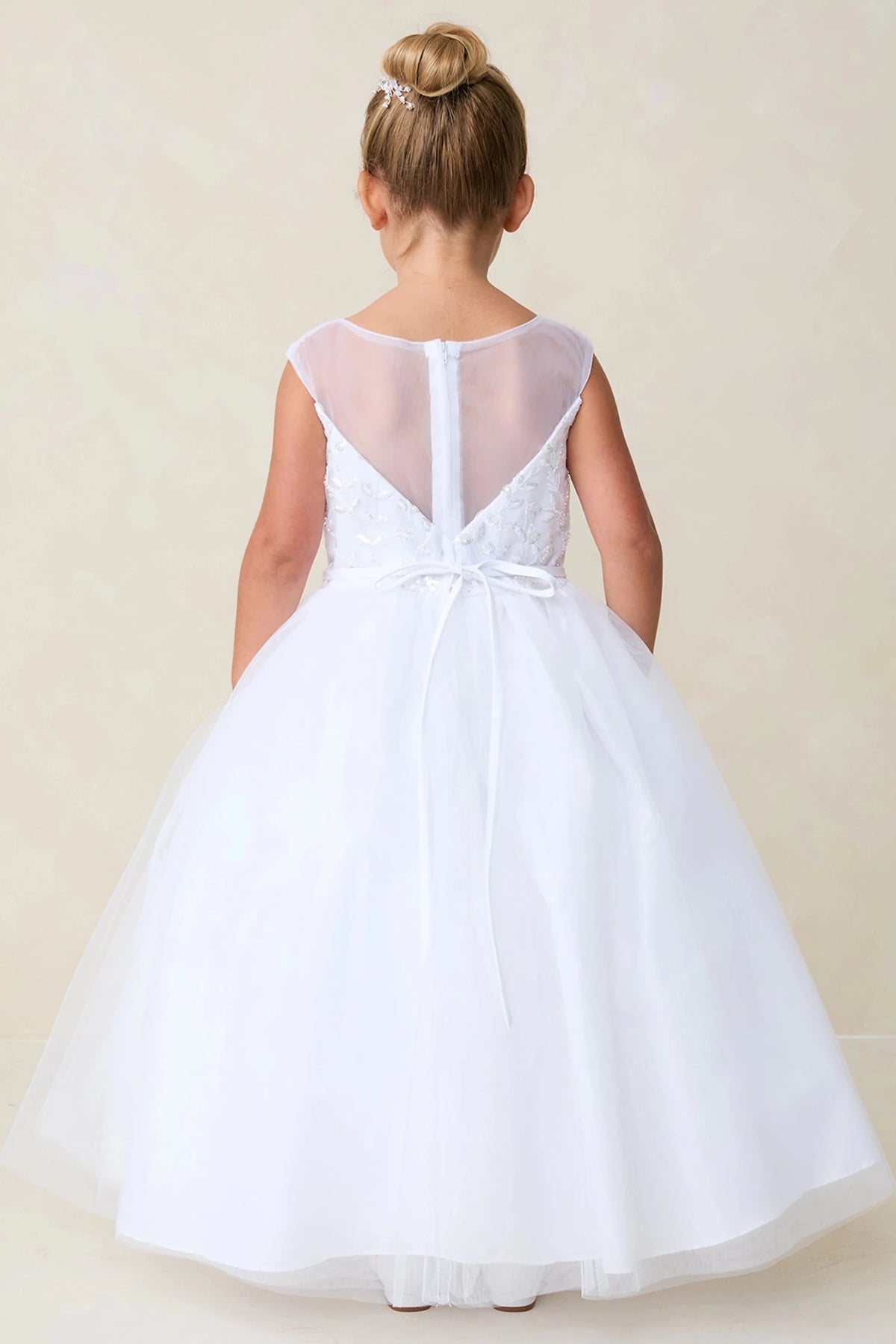 White flower girl dress featuring deep sheer back.