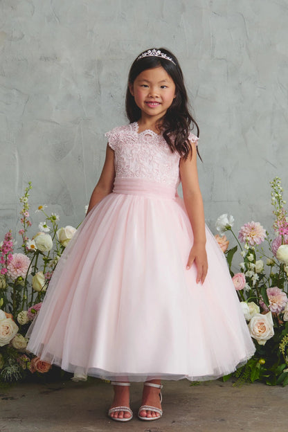 Featuring lace cap sleeves, a blush flower girl dress.
