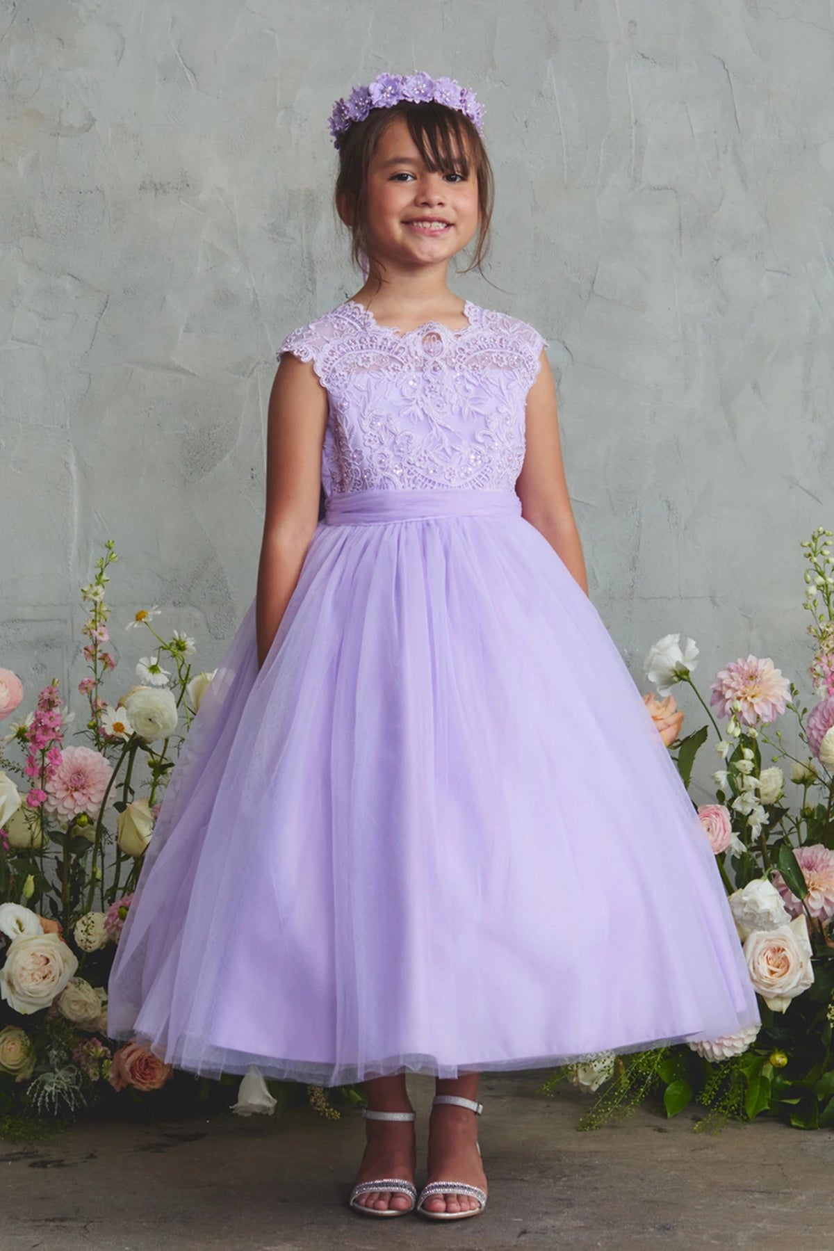 Lilac flower girl dress with lace cap sleeves.