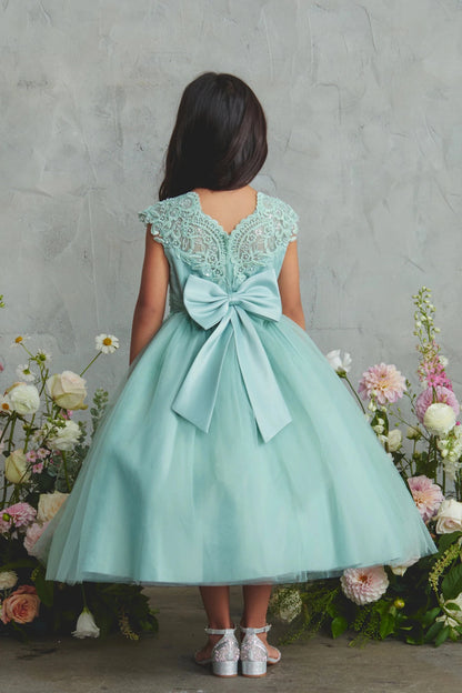 V-shaped lace back on a sage flower girl dress.