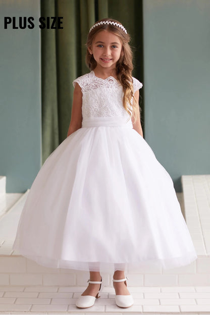 A view of a pleated waistband on the white flower girl dress.