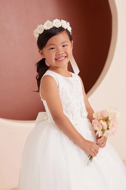 Close-up of the ivory 3d floral lace with a bow back flower girl dress.
