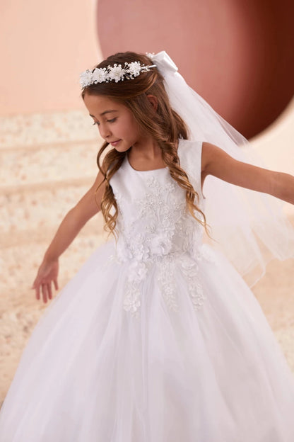 Floral skirt appliques accent the white flower girl dress.