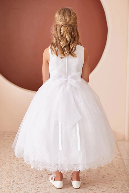 White flower girl dress detailed with satin bow at back.