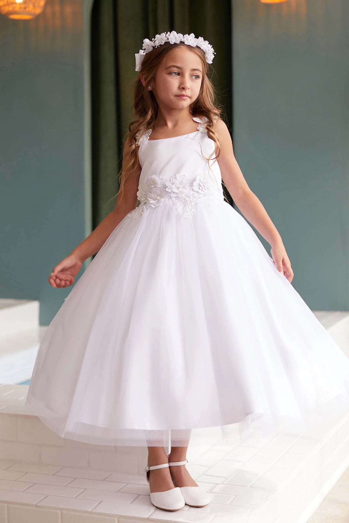 Emphasis on a floral waist applique of the white flower girl dress.
