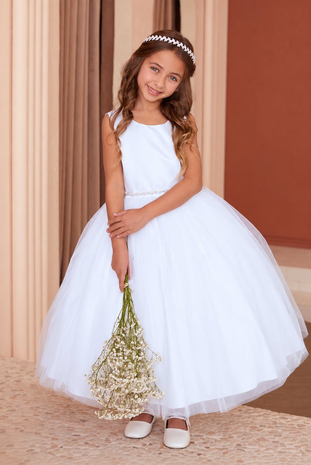 Front view of Tiptop 5863 white flower girl dress with a sleeveless satin bodice, delicate beaded waistband and tea-length tulle skirt.