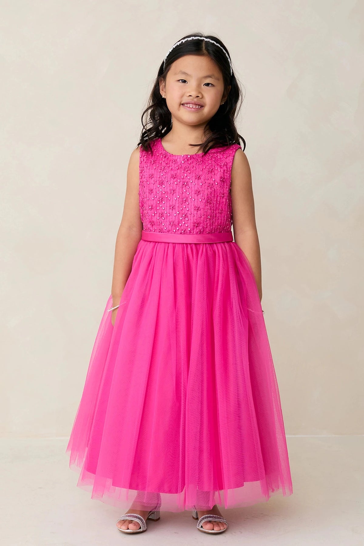 Focus on a lace bodice of the fuchsia flower girl dress.