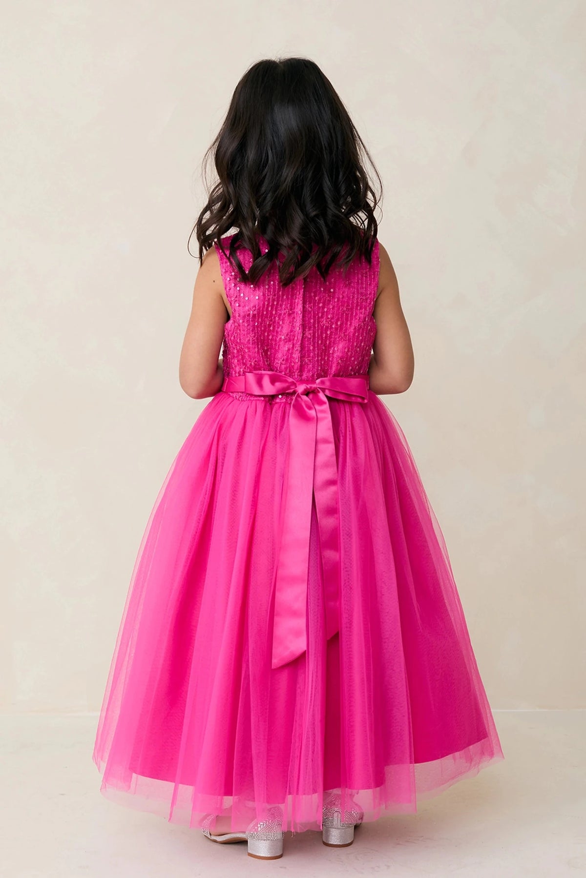 Fuchsia flower girl dress featuring a long satin back ribbon.