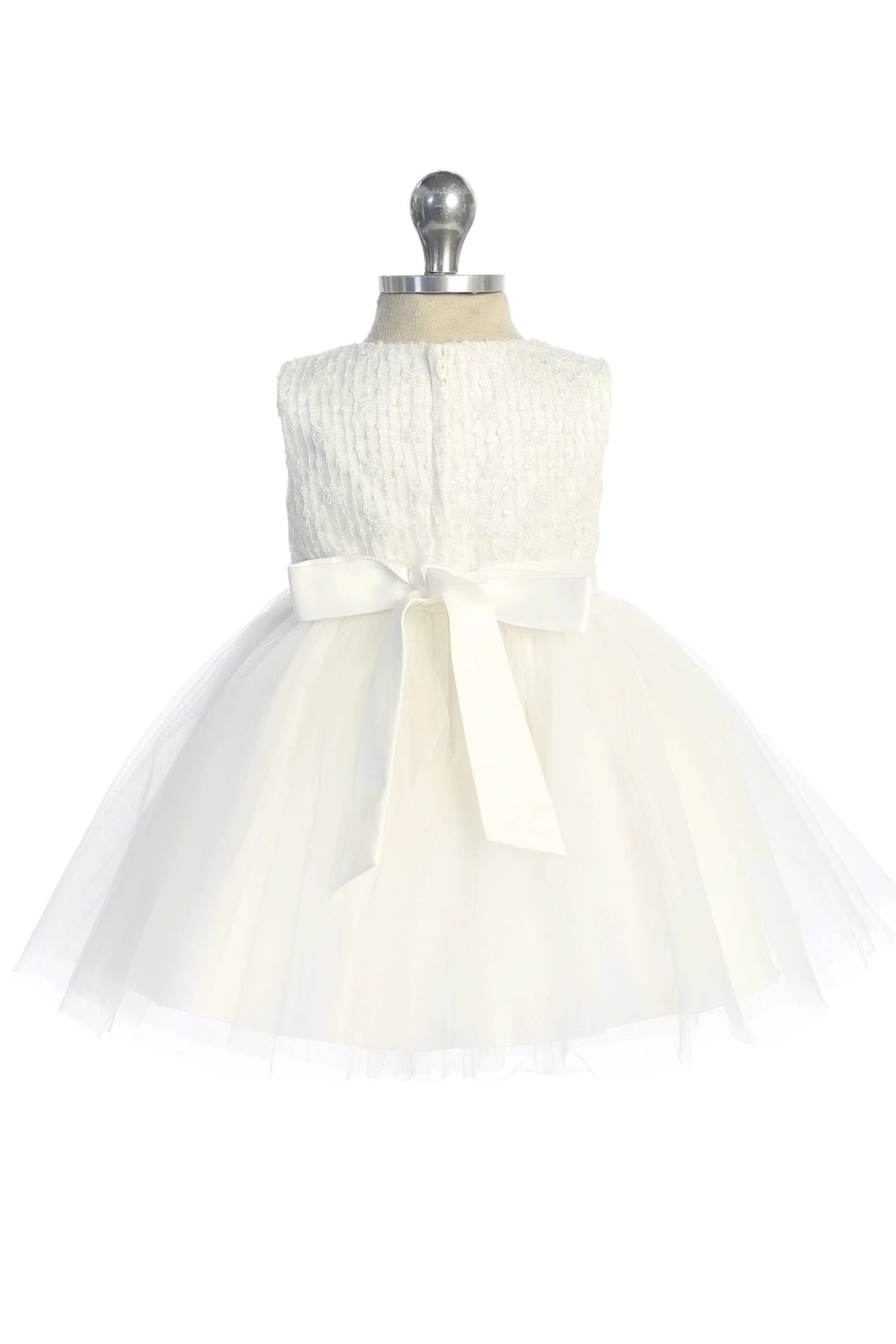 Ribbon bow centered on the back of an off-white flower girl dress.