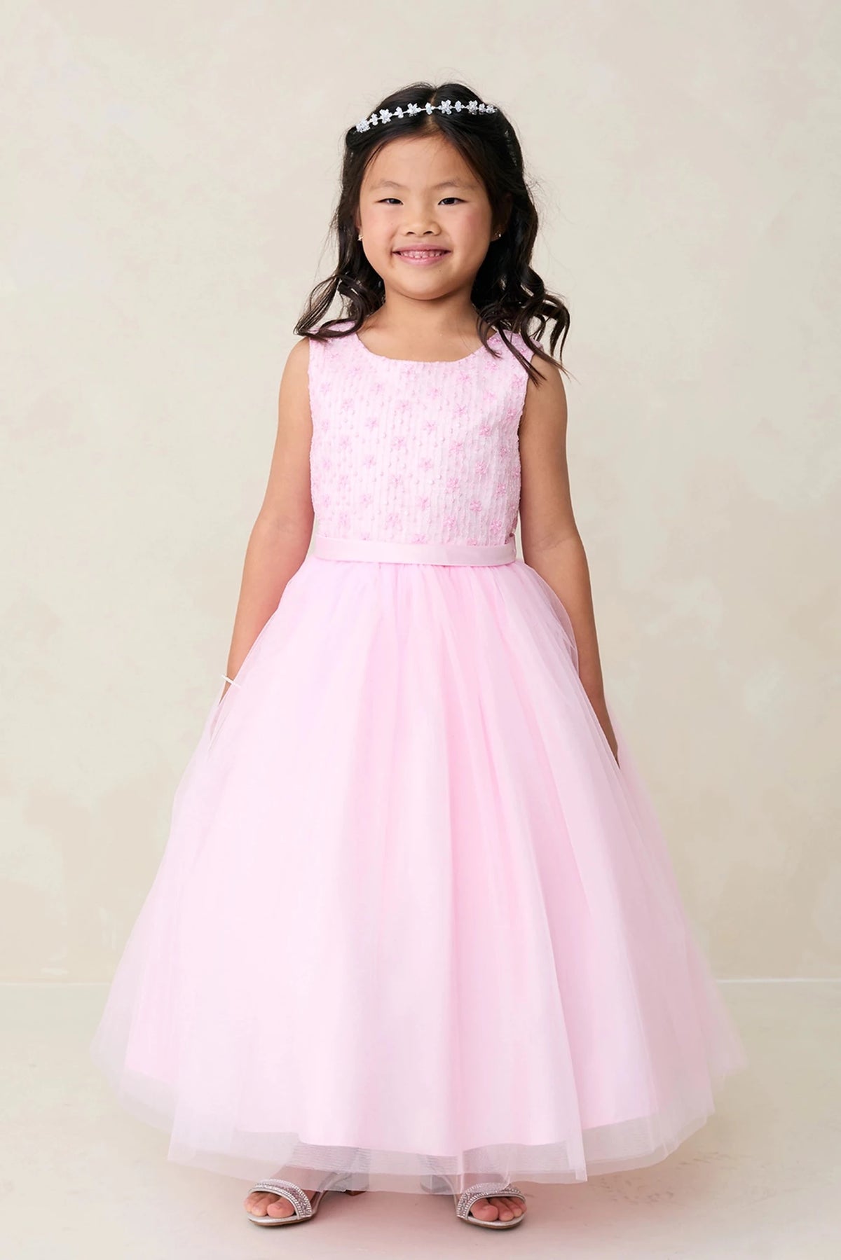 Defined by a lace-covered bodice, this pink flower girl dress.