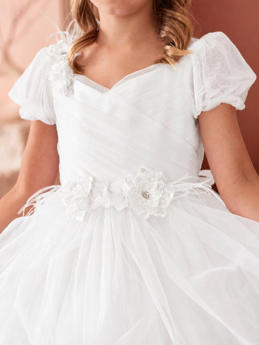 A view of 3D floral waist trim on the off-white flower girl dress.