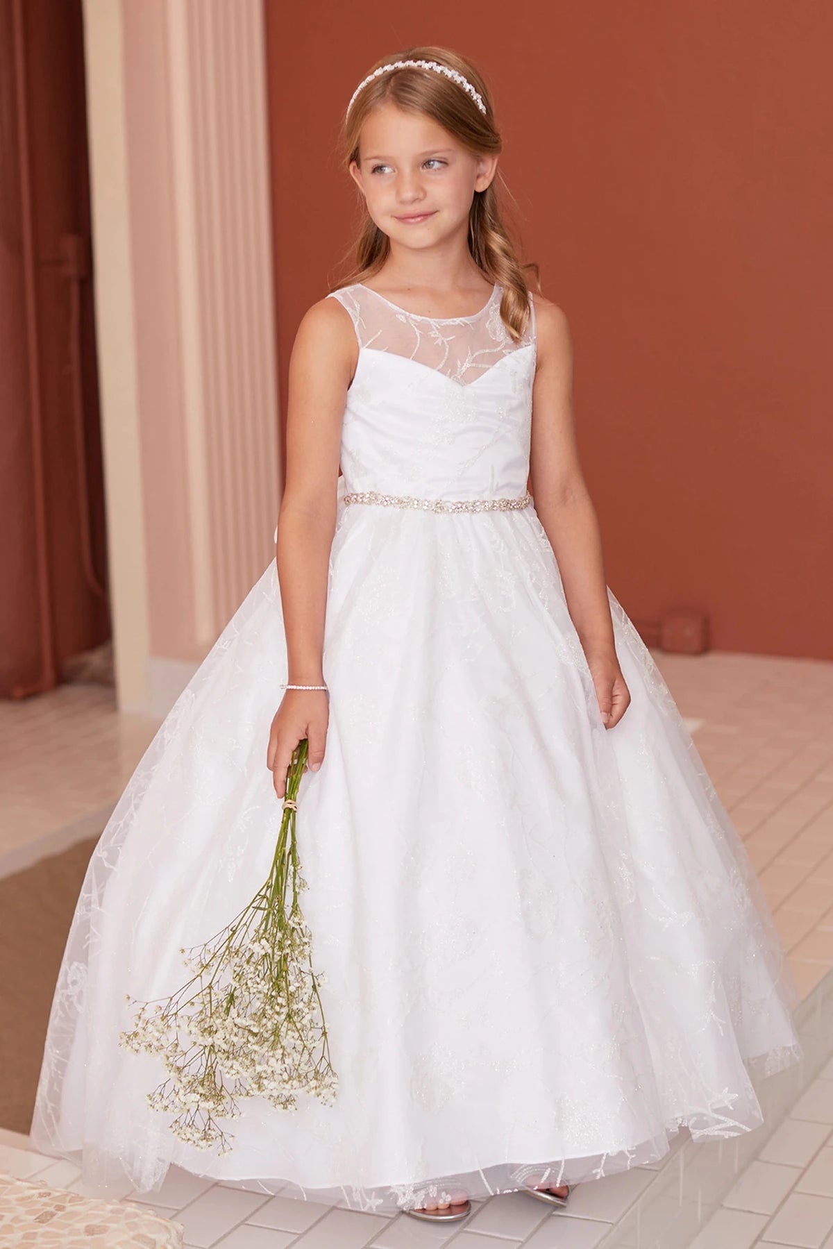 Delicate leaves embroider the off-white flower girl dress's mesh yoke.