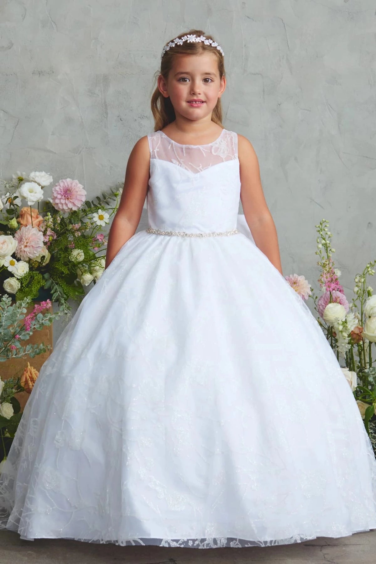 White flower girl dress featuring a full lace skirt.