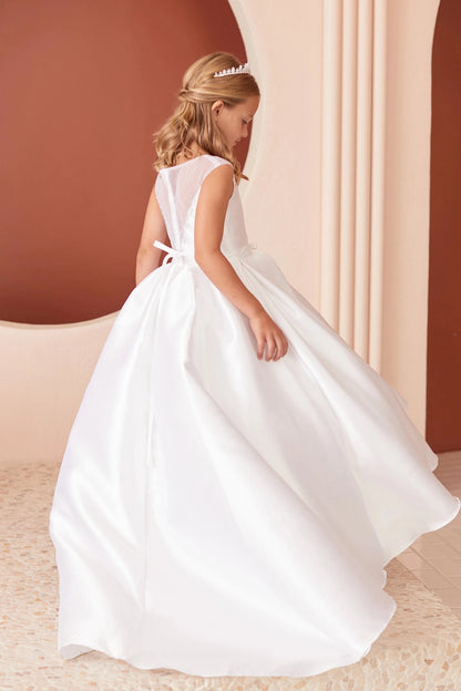 With a wide pleated skirt, a white flower girl dress.