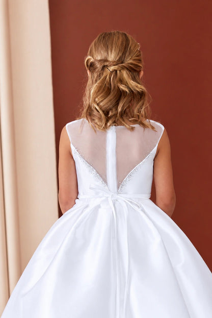 Transparent mesh forms the white flower girl dress's deep V back.