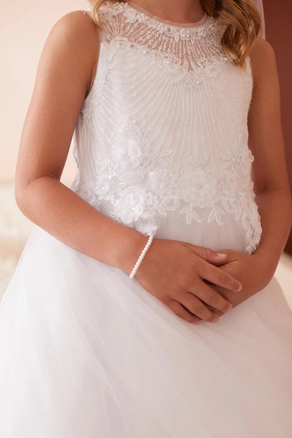 Diagonal bodice pleats accent the white flower girl dress.