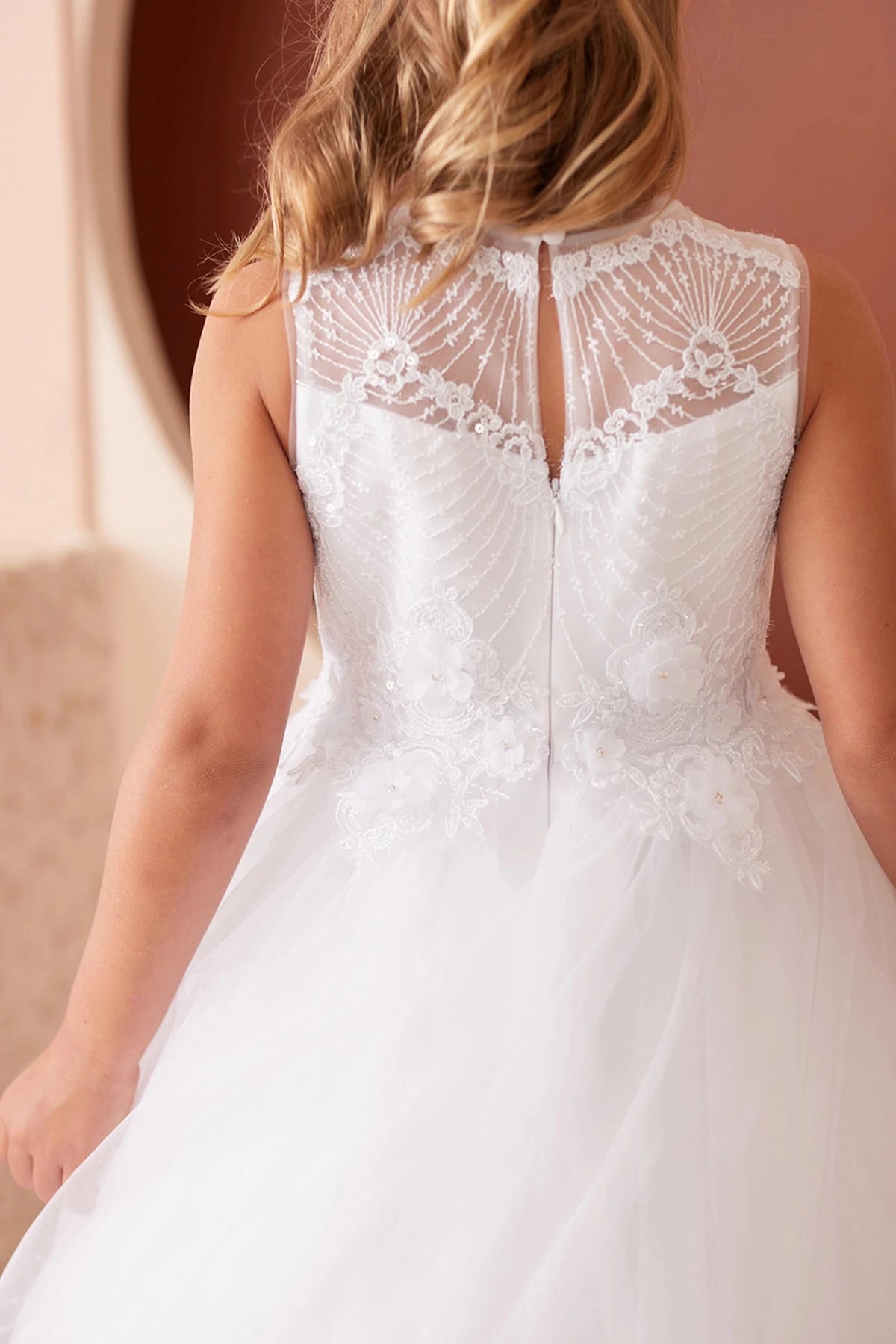 On this white flower girl dress, sheer lace back is visible.
