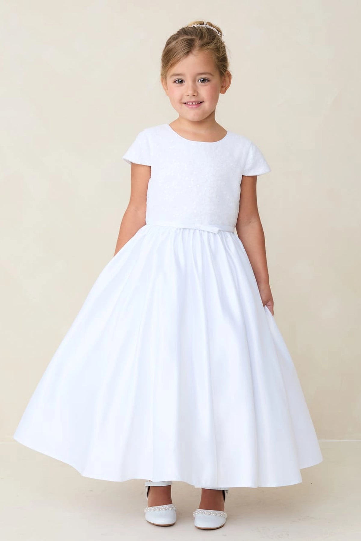 Full satin skirt accents this white flower girl dress.