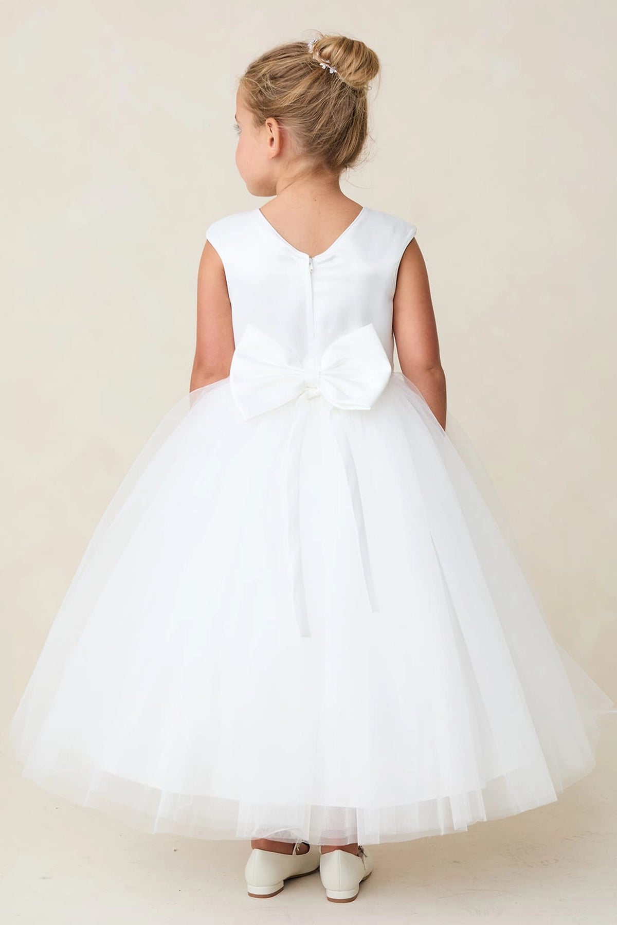 Shown here, a white flower girl dress with deep V back.