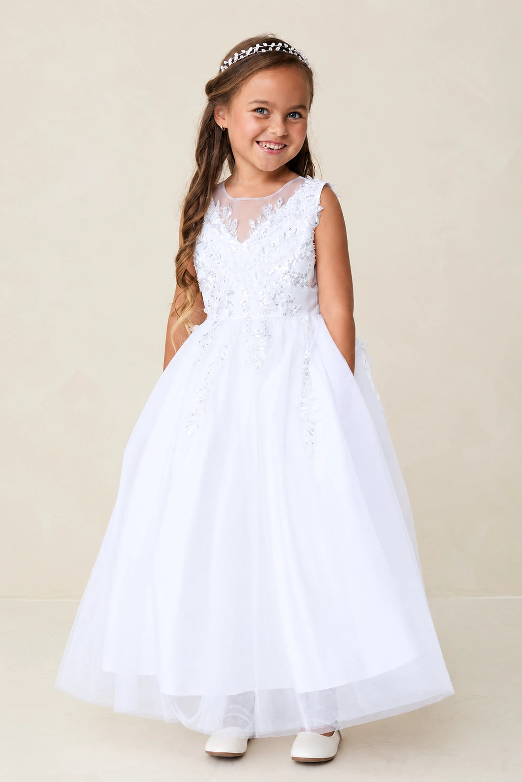White flower girl dress with a floral sleeveless bodice.