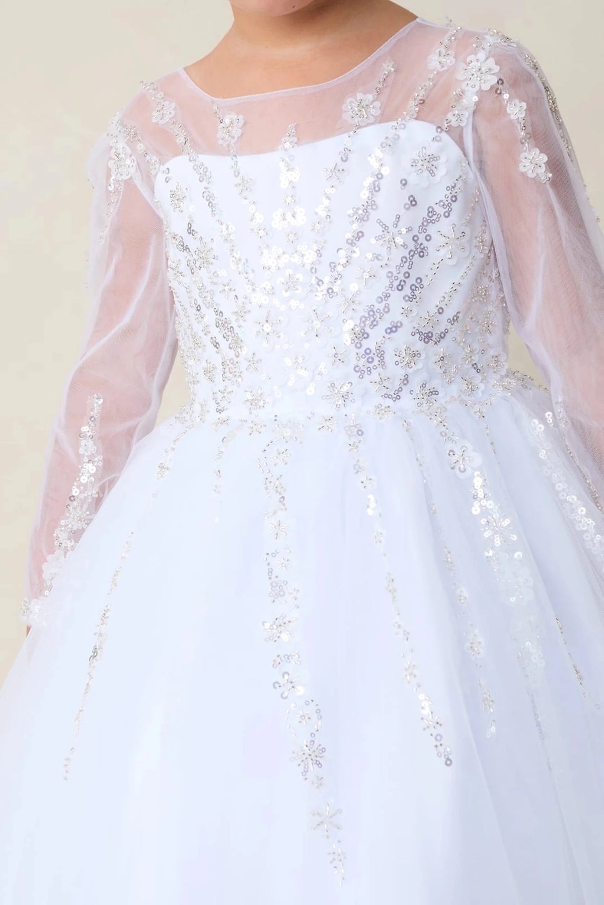 This white flower girl dress displays a beaded floral bodice.
