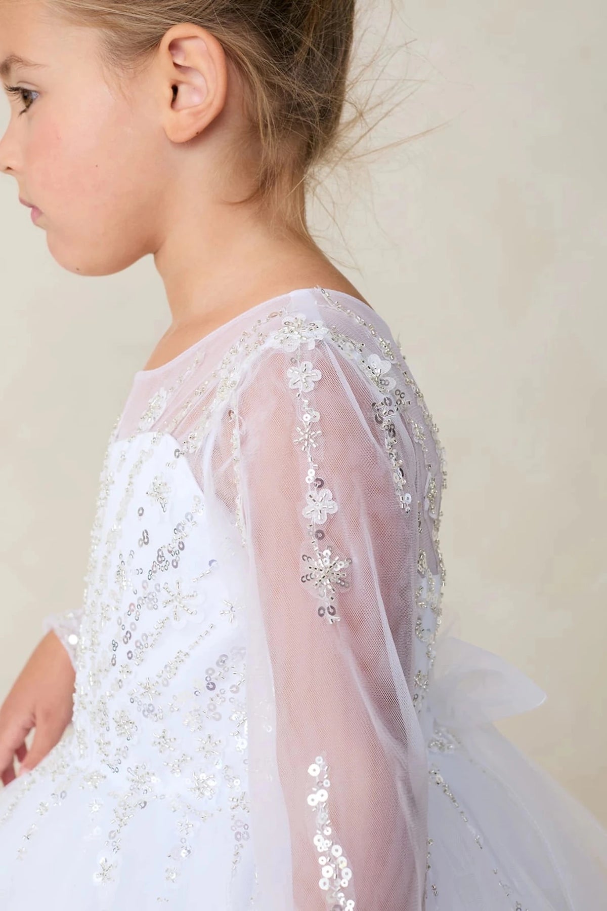 Featuring sheer upper back, a white flower girl dress.