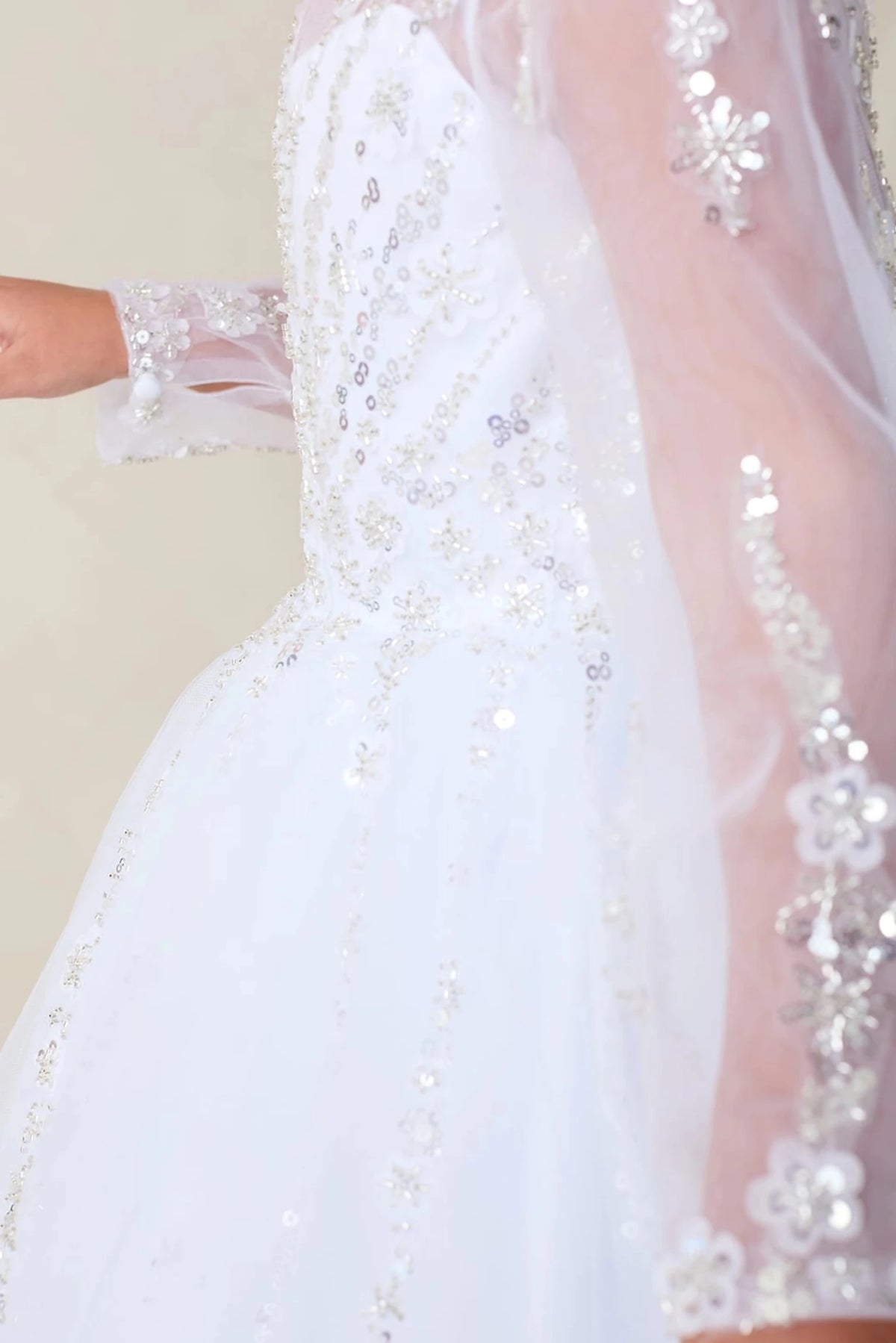White flower girl dress, showing beaded sleeve appliques.