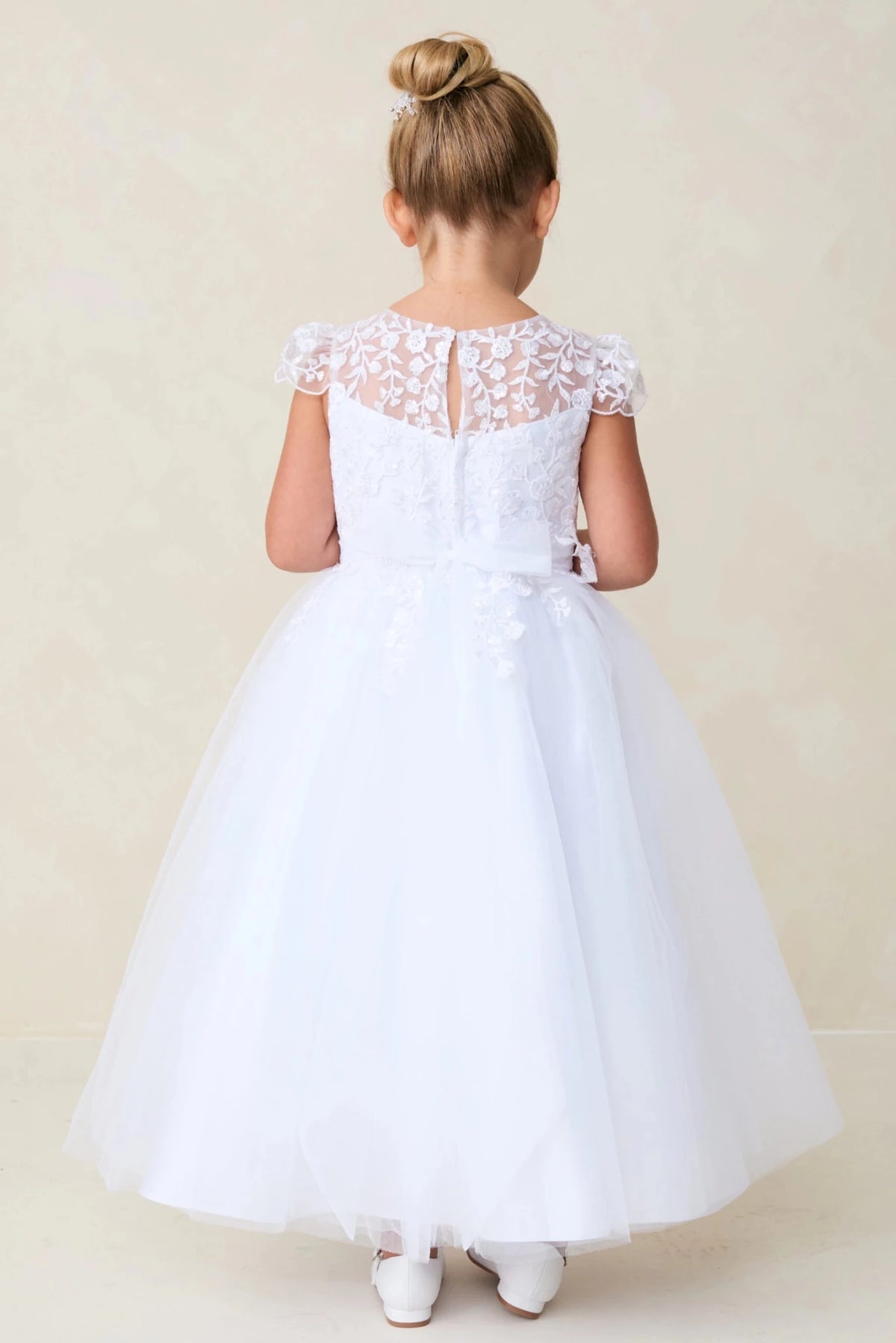 Embroidered sheer back: detail of the white flower girl dress.