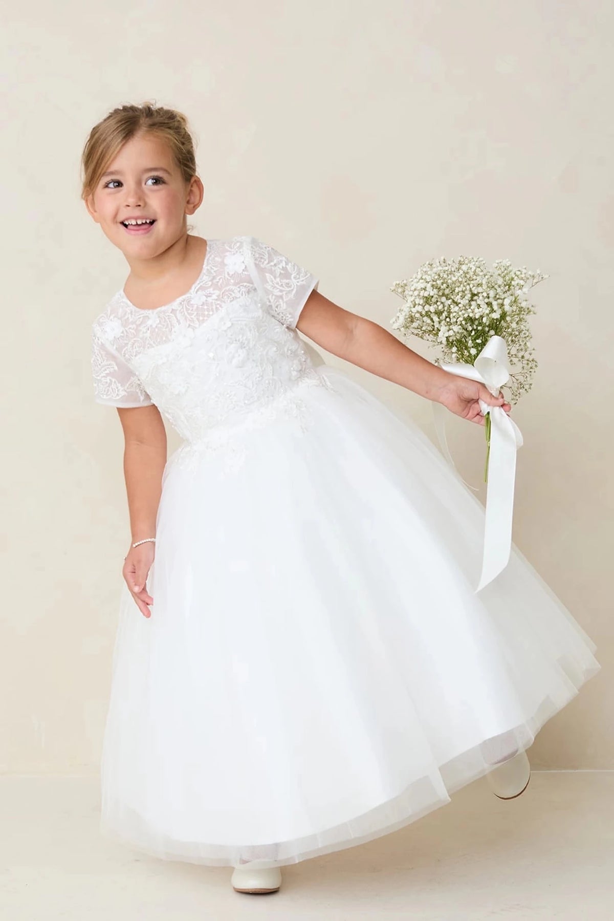 With a full mesh skirt, an off-white flower girl dress.