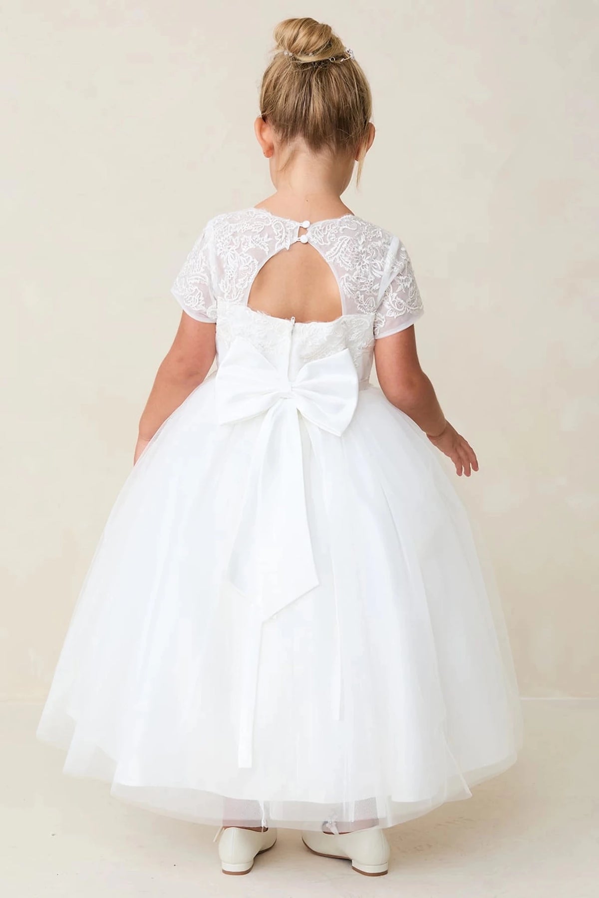 Keyhole back opening is visible on the off-white flower girl dress.
