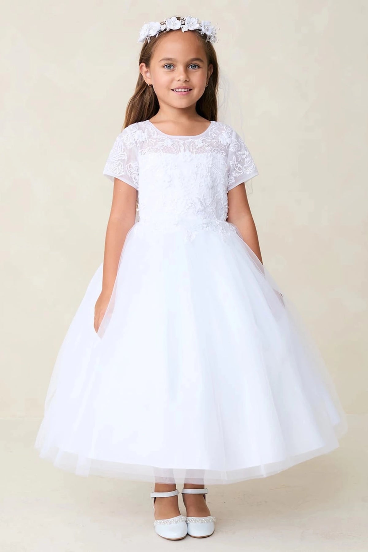 White flower girl dress with short floral sleeves.