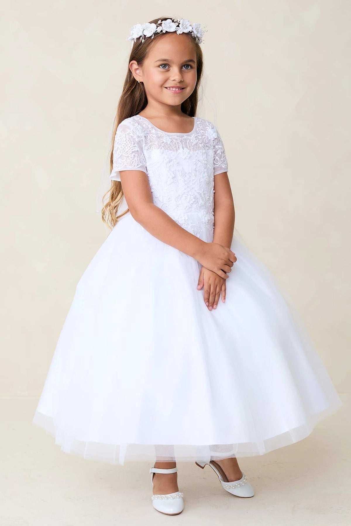 Detailed with a sheer floral neckline, this white flower girl dress.