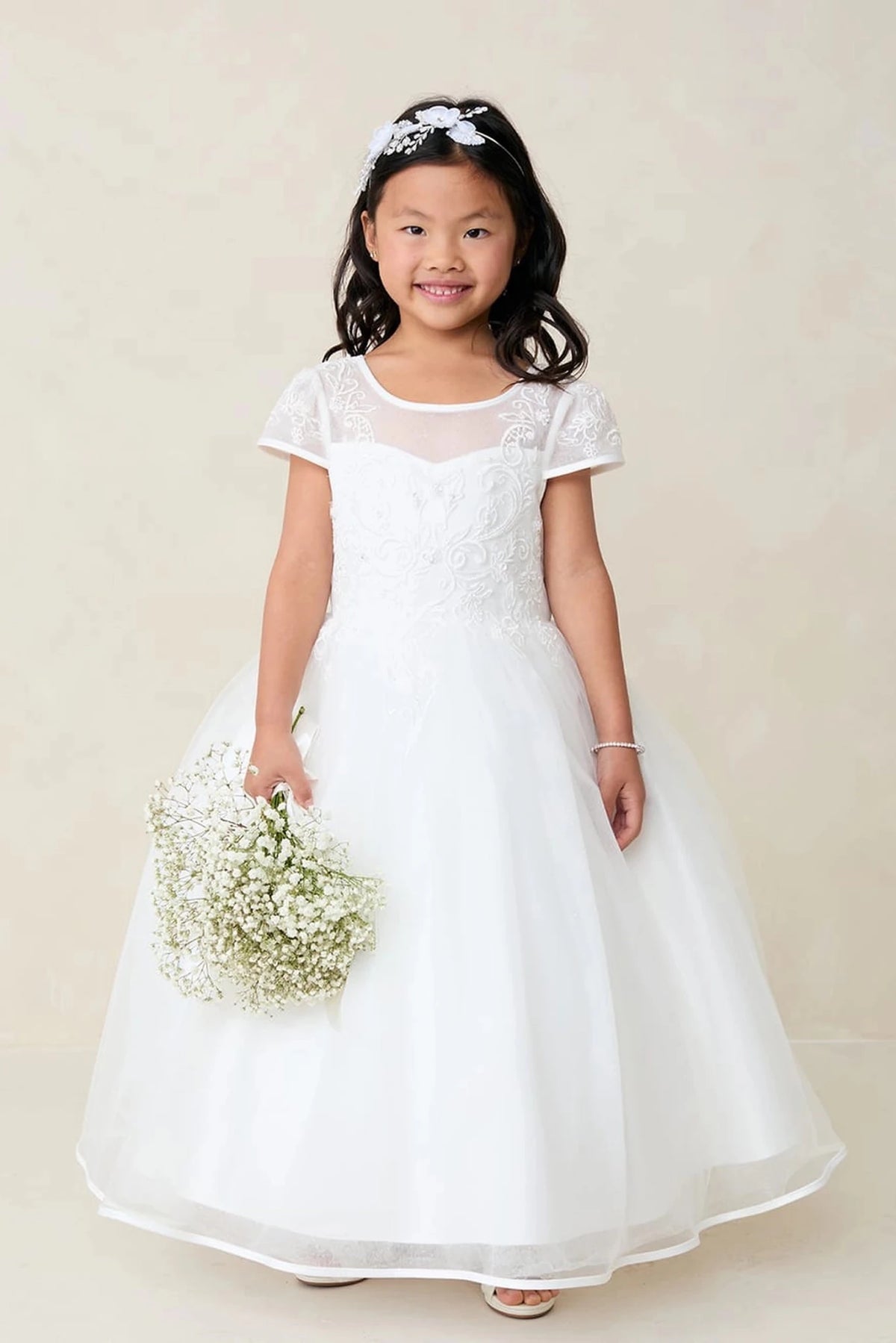 Off-White flower girl dress featuring short lace sleeves.