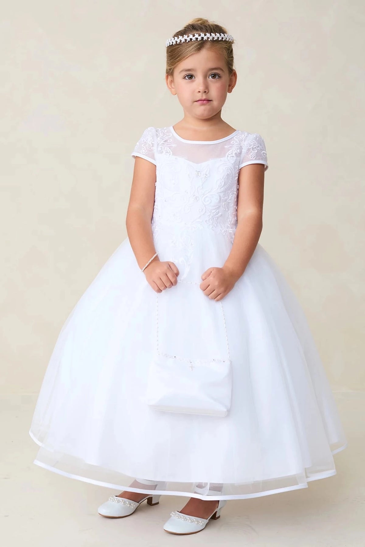 White flower girl dress featuring a full gathered skirt.