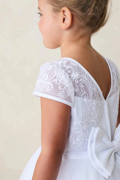Lace cap sleeve accents the white flower girl dress.
