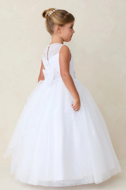 Highlighting a long tulle back skirt on a white flower girl dress.