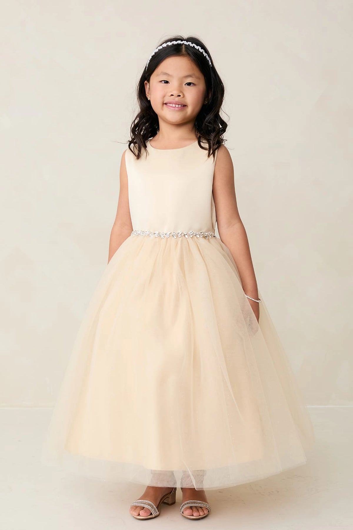 Gold kids pageant dress featuring a satin bodice and sparkling tulle skirt.