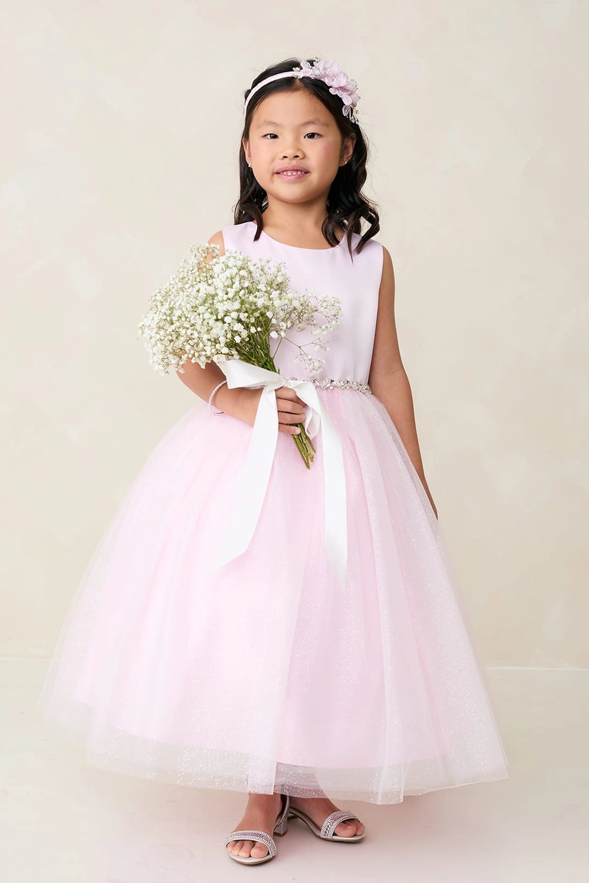 Seen from the front, this Pink kids pageant dress displays a satin bodice and sparkling tulle skirt.
